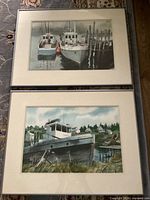 Both framed watercolor boat paintings side by side