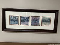 Overall view of framed quad tree photographs on wall