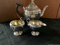 All three pieces of the silverplate service displayed together