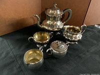 All five pieces of the beverage service displayed