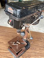 Front view of Jobmate drill press showing head, feed handle, table and base