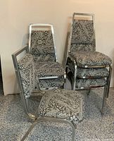 six upholstered metal chairs grouped and stacked