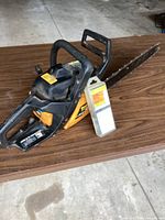 Full view Poulan 260 chainsaw with packaged chain on table