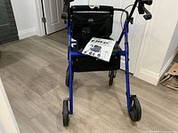 Front view of blue Hugo Elite rollator with manual on seat