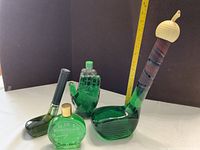 all five green glass novelty decanters displayed