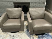 Front view of both gray swivel armchairs