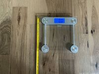Front view of Thinner glass digital scale with LCD showing 0.0, tape for scale