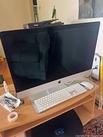 Front view of iMac on desk with Magic Keyboard and Magic Mouse