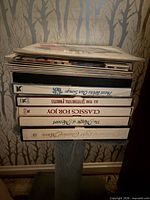 Stack of Reader’s Digest vinyl box sets and loose records showing spines with titles