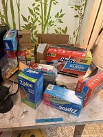 Overview of Ziploc, Hefty boxes, batteries and bulbs on countertop