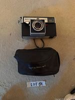 Front view of Bell & Howell Autoload camera with case visible