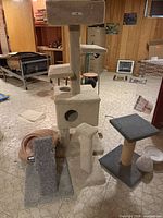 All items grouped: tall beige cat tree, dark grey tower, scratch ramp, beige post tower, pet bed, flat scratch pad