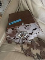 Clock housing with dial and detached roof