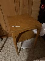 Full view of end table showing overall design and wear