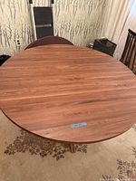 Top view of round walnut-tone dining table