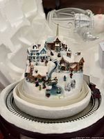 Miniature village base with train track and snow scene