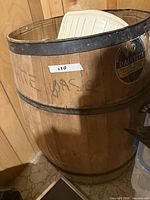 Full view of wooden milk cask barrel with Dairylea logo, iron hoops, and label