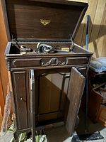 Full view of Victrola cabinet with lid open and doors ajar