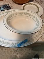 Top view showing oval bowl on platter with pattern detail