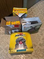 Four trash bag product boxes arranged on floor