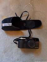 Olympus Super Zoom 3500DIX camera with wrist strap and carrying case overview