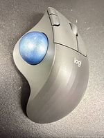 Top angled view showing blue trackball and ergonomic shape