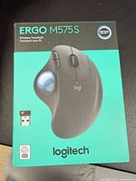 Front of sealed retail box showing Logitech ERGO M575S trackball image and branding