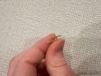Close-up showing side profile of one stud earring and post