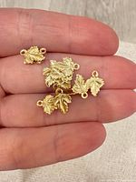 Close-up of charms in hand showing detail and scale