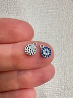 Front and back of both sterling silver round pave charms shown; 925 stamp visible