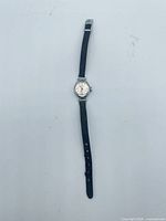 Full view of Timex quartz wristwatch laid flat showing dial, strap and buckle