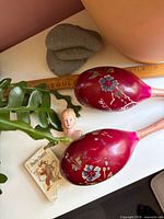 Maracas pair, half-doll head, sealed cards together on surface