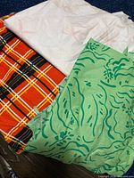 Stack of three distinct fabric pieces