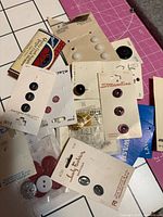 Pile of button cards and loose buttons showing quantity and variety