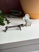 Zebra and metal dog side by side on shelf