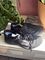 Full view of both black Vans Ultrarange sneakers showing overall condition