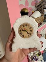 Front view showing clock face design and overall shape