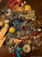 Top-down view of full pile showing variety of jewelry pieces and findings