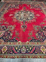 Full view of Persian Tabriz rug showing central medallion and borders