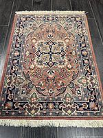 Full view of rug showing overall pattern, fringe and colors