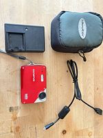 Camera, charger, USB cable and case overview