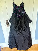 Front view of full ball gown showing sequin bodice and black taffeta skirt