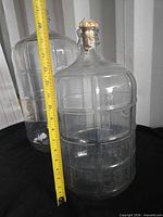 Both glass carboys side by side showing relative sizes