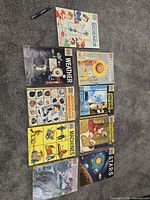 All ten How and Why Wonder Books laid out on carpet