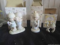 Three figurines with their boxes displayed