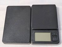 Scale closed with lid beside LCD and buttons