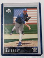 Front of Roy Halladay Upper Deck MVP card showing action photo, card number, and protective sleeve