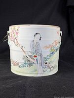 Front view showing full painted scene and handles