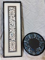 Framed silk panel and lacquer tray side by side