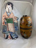Front view of plaster figurine and cloisonné vase